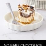 A slice of creamy Chocolate and Peanut Butter Pie topped with chopped pieces, served on a white plate with a fork, makes the perfect no-bake treat.