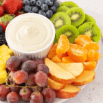 A colorful fruit platter with the dessert.