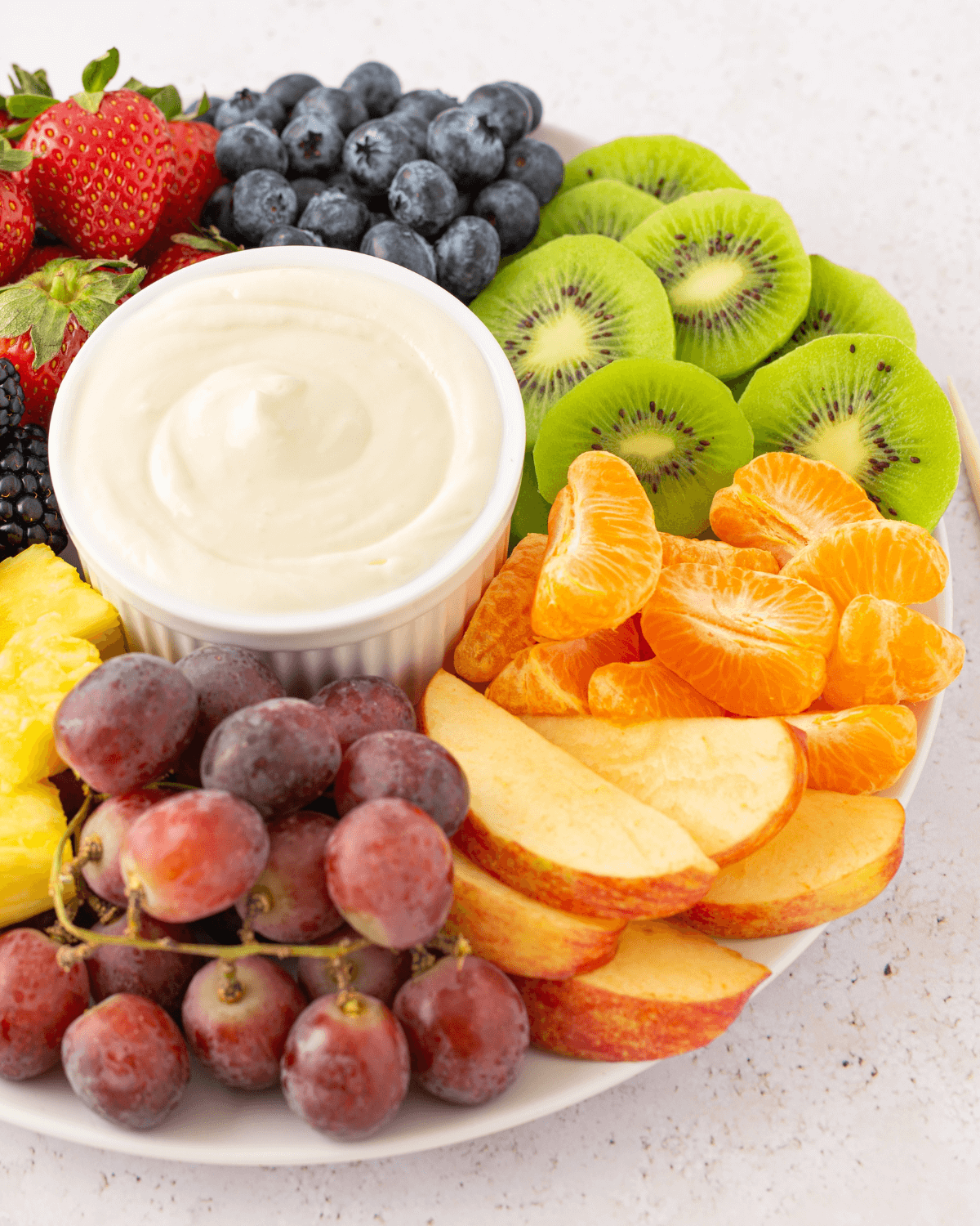 A colorful fruit platter with the dessert.