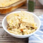 A white bowl on a wooden table.