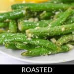 A delightful plate of Garlic Parmesan Green Beans, expertly roasted and garnished with refreshing lemon slices.