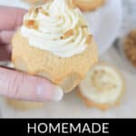 A hand holding a homemade cinnamon cupcake with maple frosting. More delectable cinnamon cupcakes are visible in the background. The text reads: "Homemade Cinnamon Cupcakes w/ Maple Frosting.