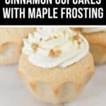 Image of a cinnamon cupcake topped with white maple frosting and sprinkled with small brown crumbles, set on a white surface. The text overlay reads "Homemade Cinnamon Cupcakes with Maple Frosting.