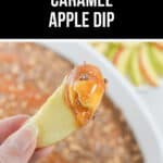 A close-up of a hand holding an apple slice dipped in Caramel Apple Dip with a crumbly topping, with a dessert dish in the background. The image is captioned “Quick & Easy Caramel Apple Dip.”