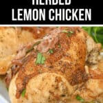 A close up of herbed lemon chicken shows its golden, crispy skin and succulent, juicy interior, garnished with fresh herbs.