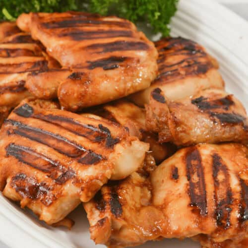 A white dish of the Asian grilled chicken.
