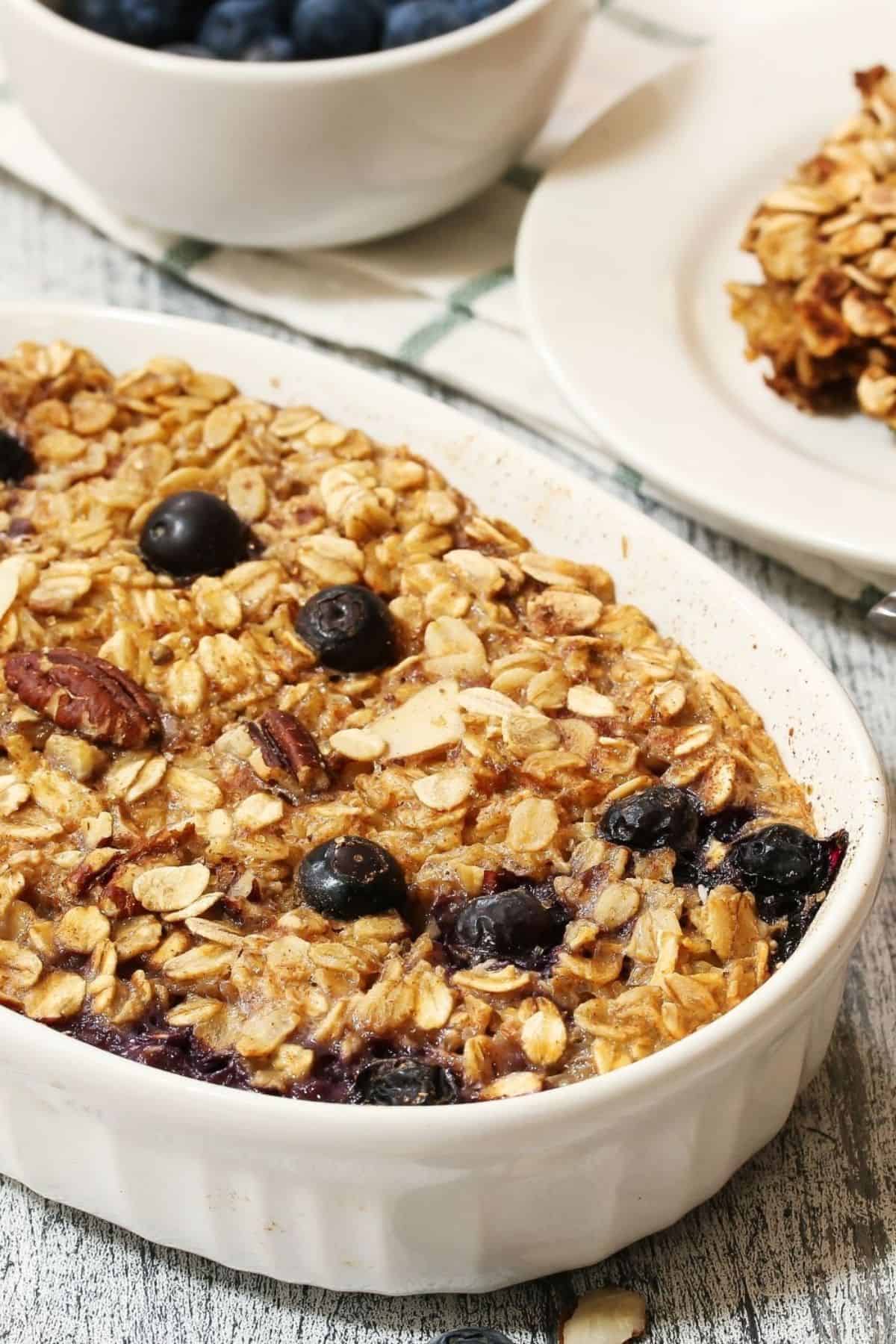 A white baking dish with blueberry baked oatmeal.