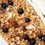 A warm breakfast meal with fruit on top.