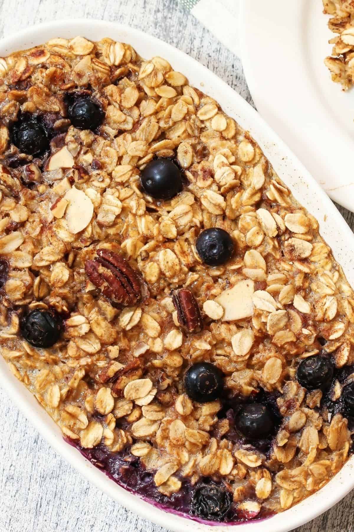 A warm breakfast meal with fruit on top.