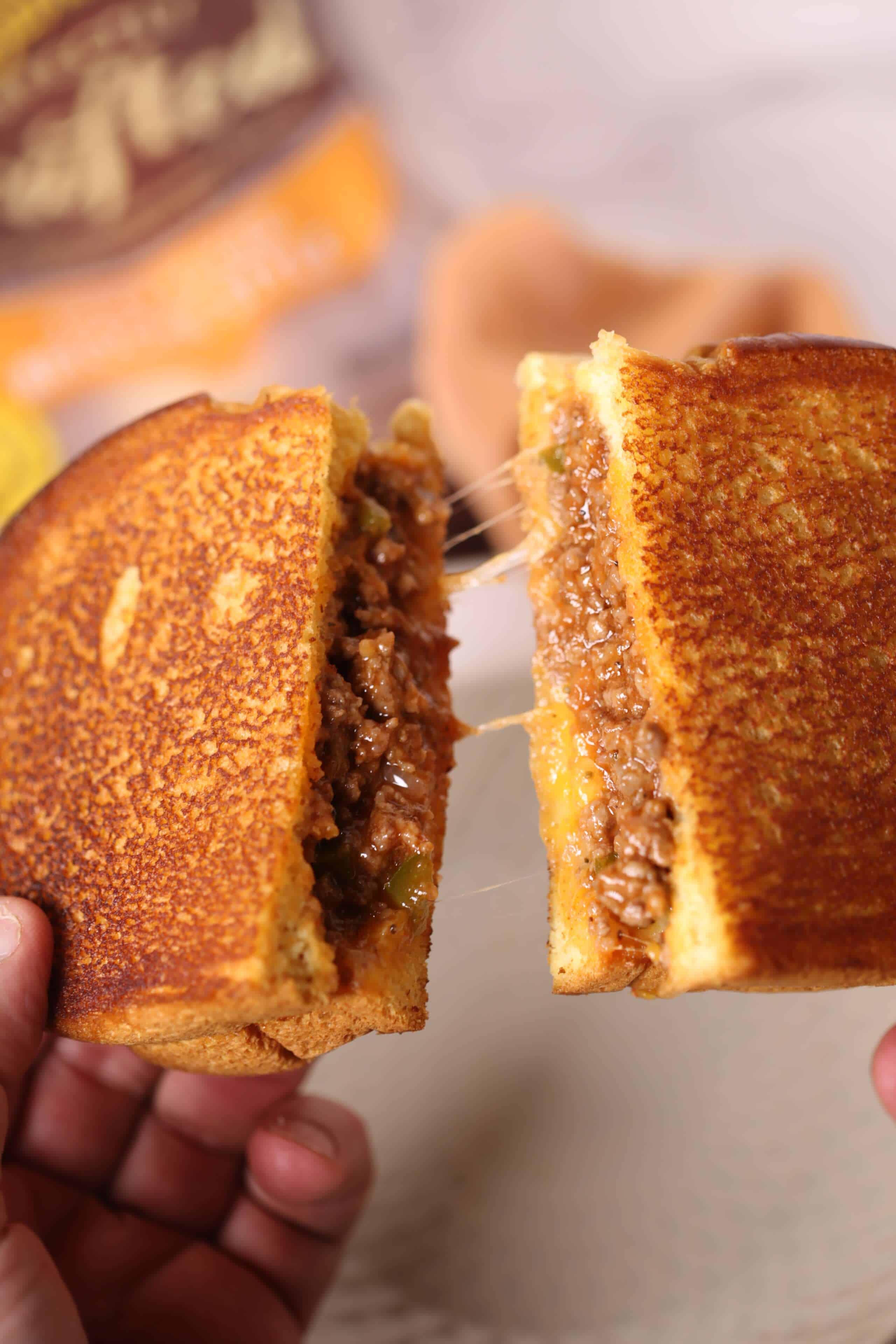 2 halves of sloppy joe grilled cheese pulled apart
