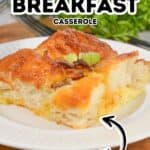 A slice of Biscuit Breakfast Casserole with melted cheese and green onion garnish on a white plate, labeled as easy to make.