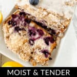 A sliced lemon blueberry loaf with icing and blueberries on top is displayed on a white plate. The text reads, "Moist & Tender Lemon Blueberry Loaf," showcasing the perfect treat.