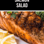 A close-up of a grilled salmon fillet, garnished with fresh herbs and lemon slices, invites you to savor our signature Grilled Salmon Salad.