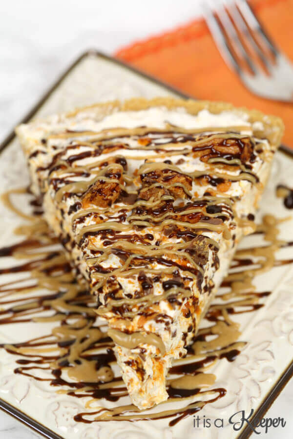 No Bake Butterfinger Pie on white floral plate. 