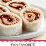 A plate of Peanut Butter and Jelly Pinwheel Sandwiches on a table.
