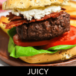 A Steakhouse Burger with lettuce, tomato, bacon, and a dollop of sauce between a seeded bun. A knife is inserted into the top bun, placed on a wooden board. Text reads "Juicy Steakhouse Burger".
