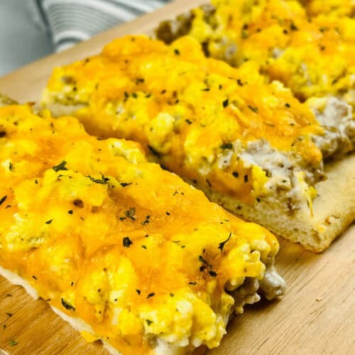 A square of the school breakfast pizza on a cutting board.