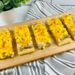 A board with slices of the school breakfast pizza with sausage gravy.