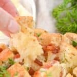 A hand pulling out a piece of the appetizer.