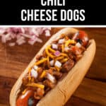 A chili cheese dog topped with chili, melted cheese, and chopped onions sits on a wooden surface with a backdrop of more onions. Text reads "The Very Best Chili Cheese Dogs.