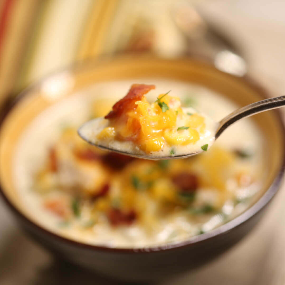 Easy Chicken Corn Chowder in a bowl, Chicken Corn Chowder on a spoon. 