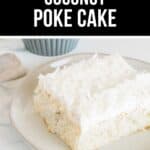 A slice of Coconut Poke Cake topped with shredded coconut is served on a white plate.
