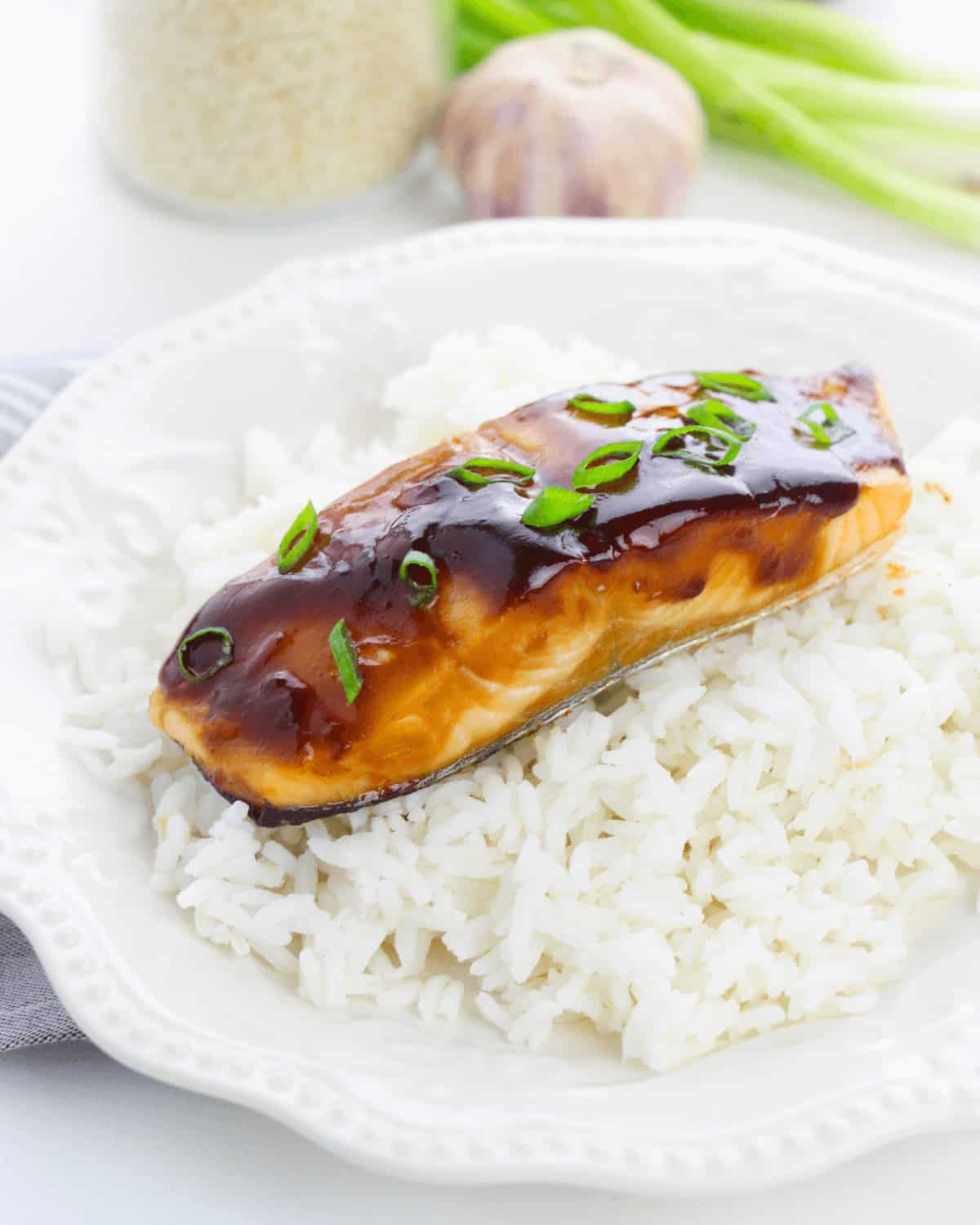  Fillet served over white rice garnished with green onions.