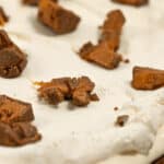 Close-up of the dessert topped with chunks of brown chocolate or candy.