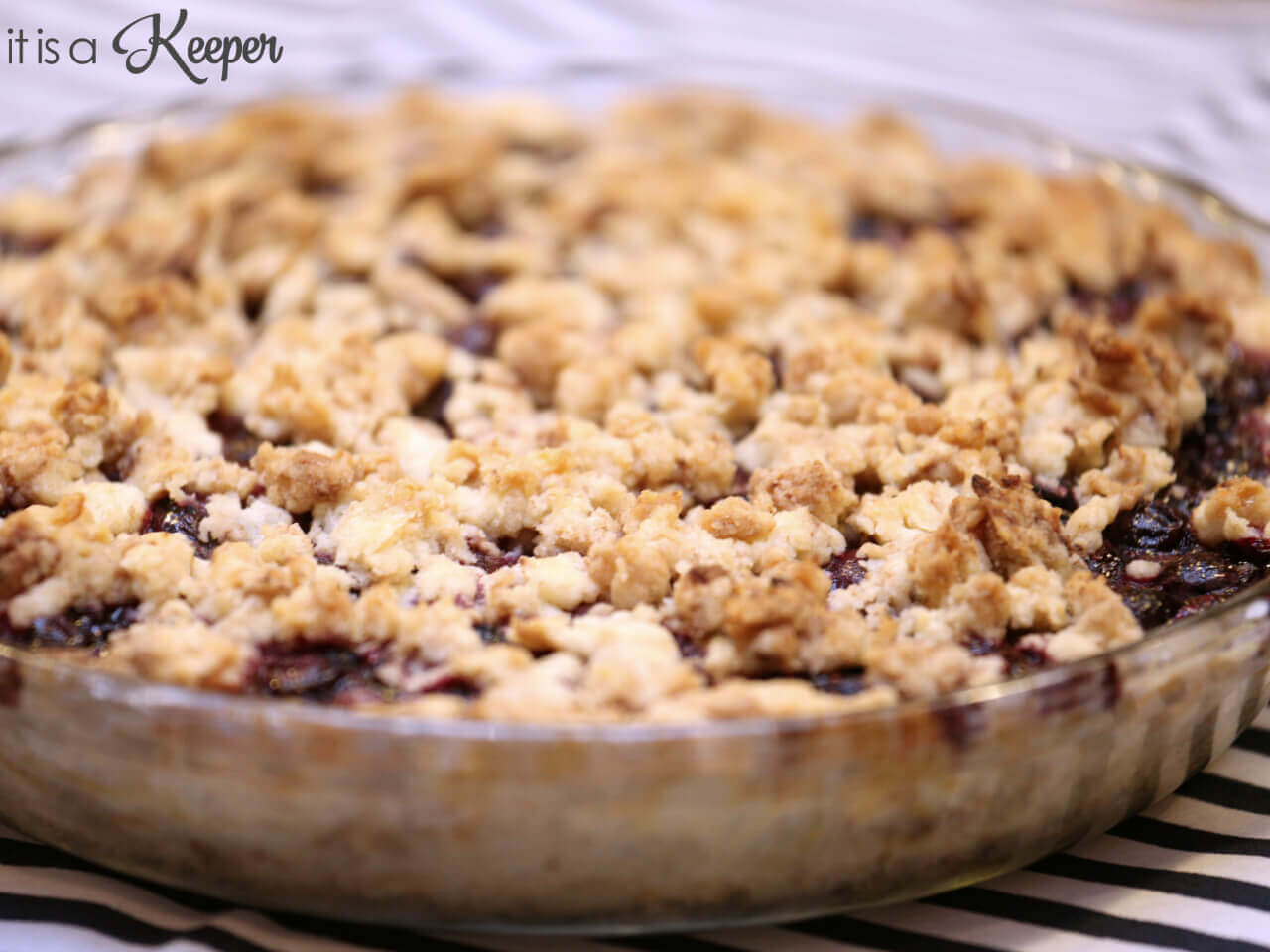 Blueberry Crumb Pie in a clear dish.