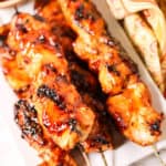 Grilled Sticky Chicken on a white plate with paisley napkin