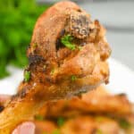 A hand picking up a drumstick.