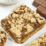 Twix oatmeal caramel bars on a white tray.