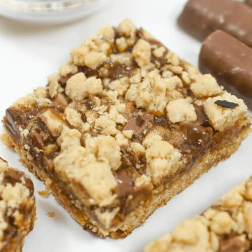 Twix oatmeal caramel bars on a white tray.