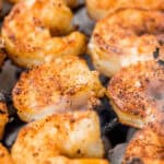 Shrimp on skewers on a grill.