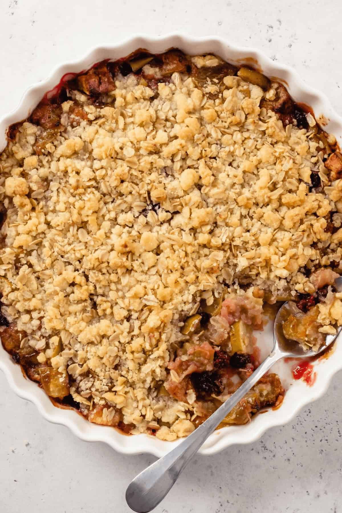 A spoon in the apple blueberry crisp.