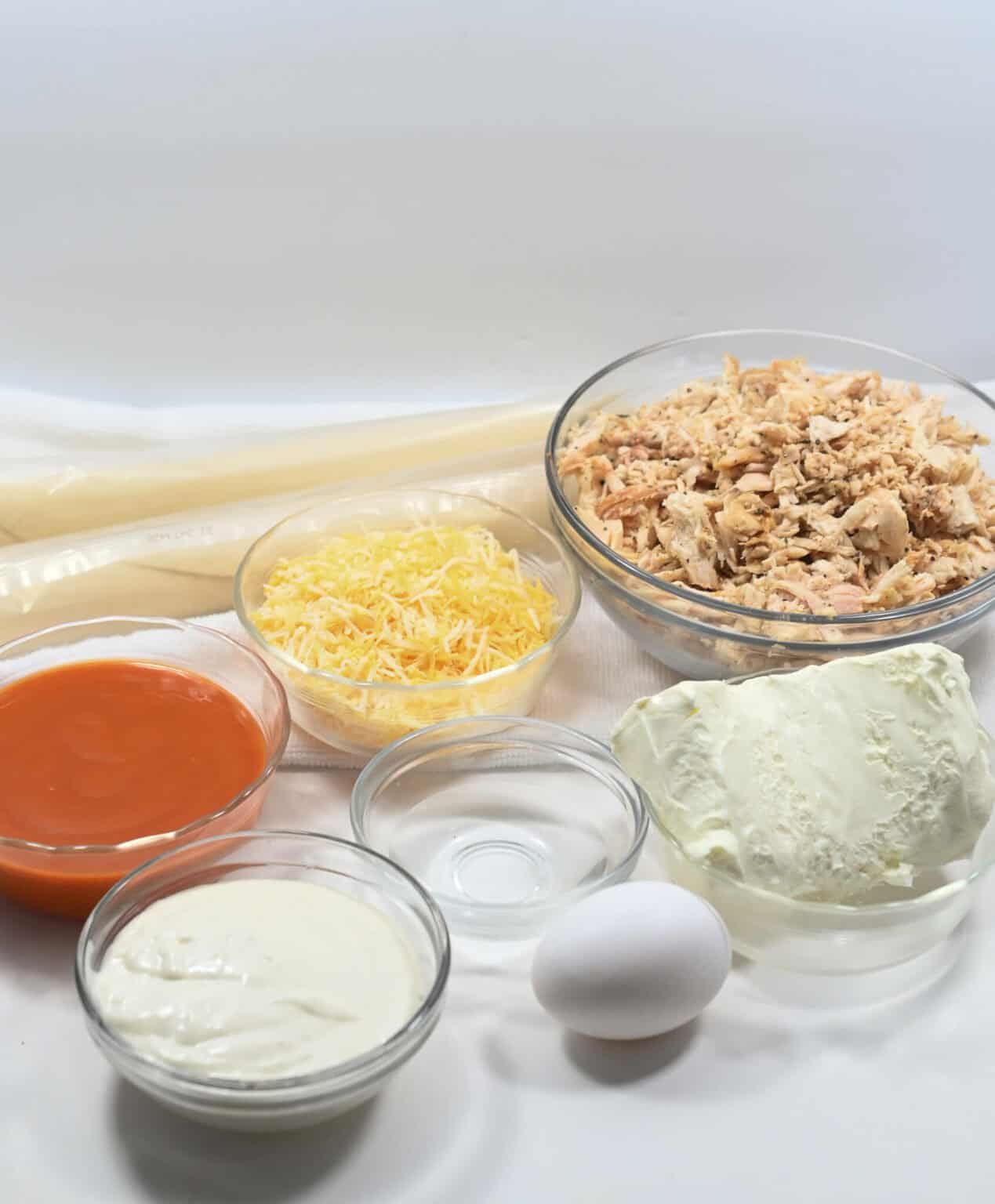 Shredded meat, cheese, sauce and dough for the dish.