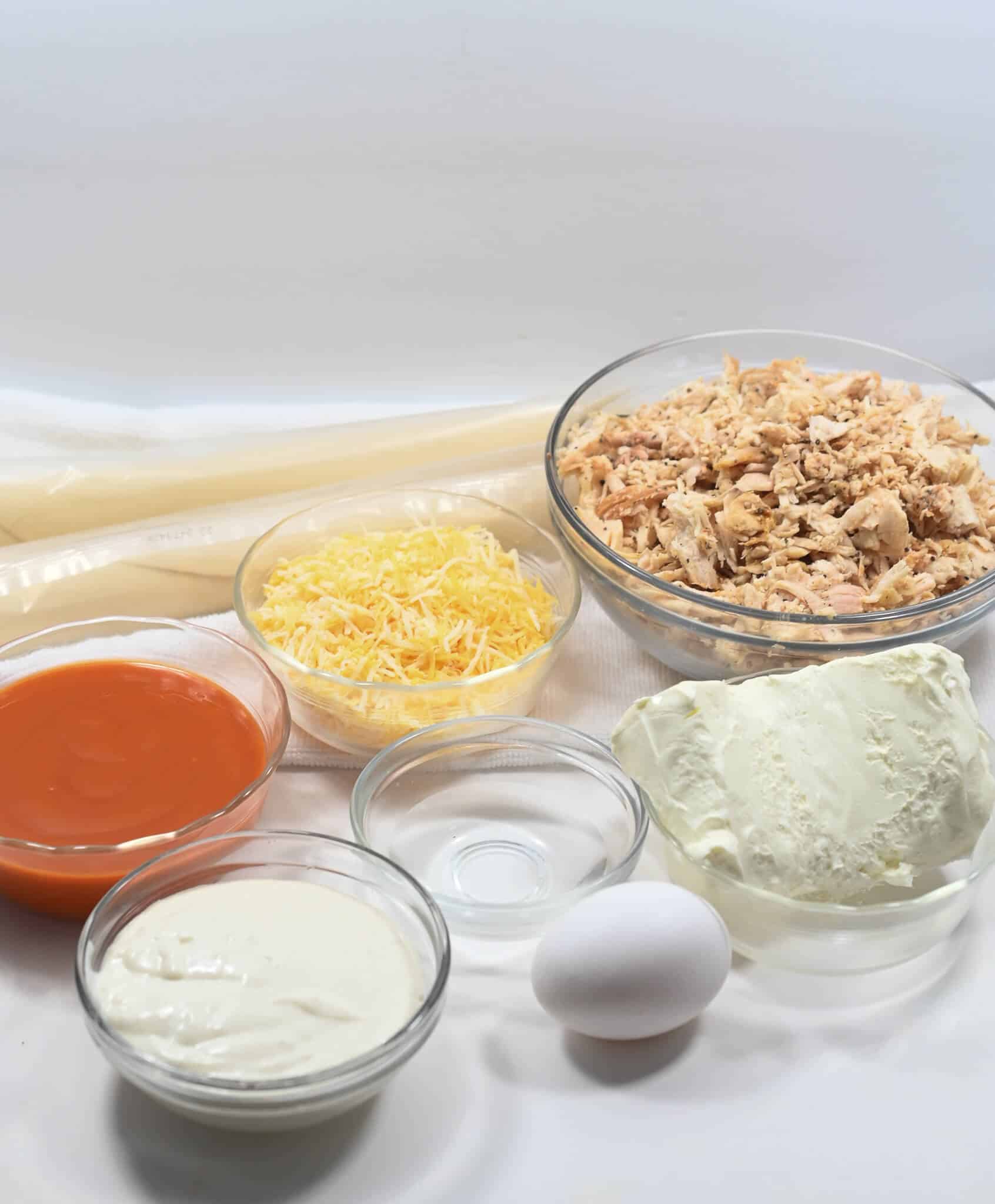 Shredded meat, cheese, sauce and dough for the dish.