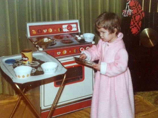 Christina cooking in her play kitchen