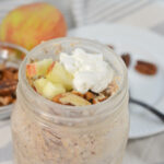 A spoon next to the mason jar of oats.