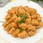 A top view of the sweet potato gnocchi on a white plate.