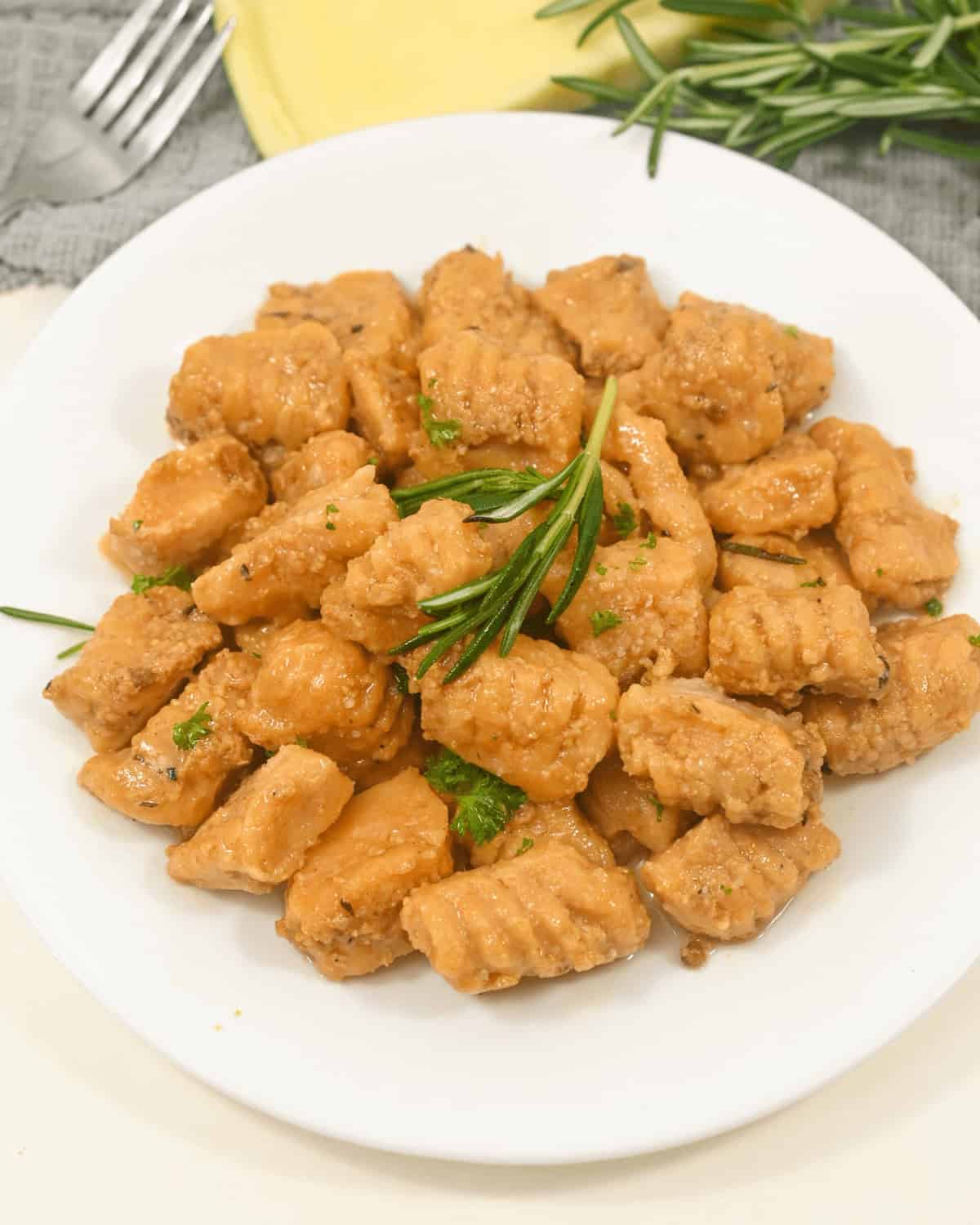A top view of the sweet potato gnocchi on a white plate.