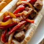 The meal on a roll on a plate.