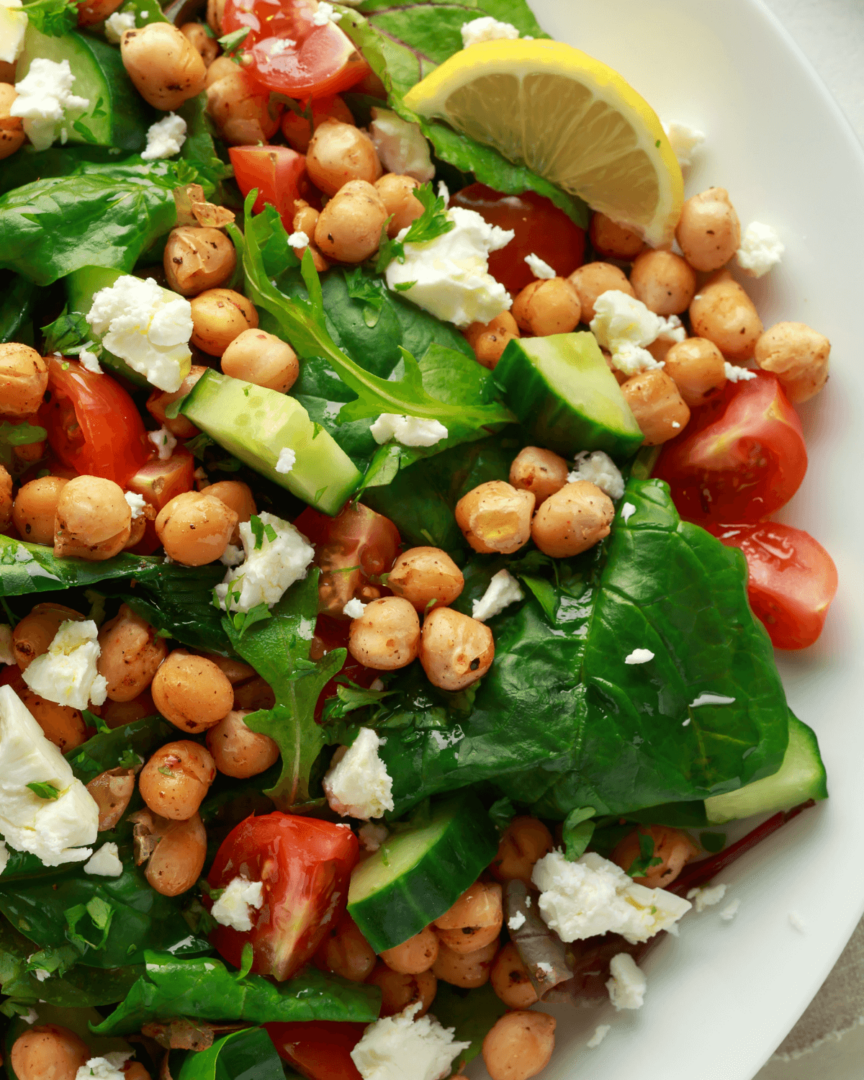A white bowl of the chickpea and cucumber salad.