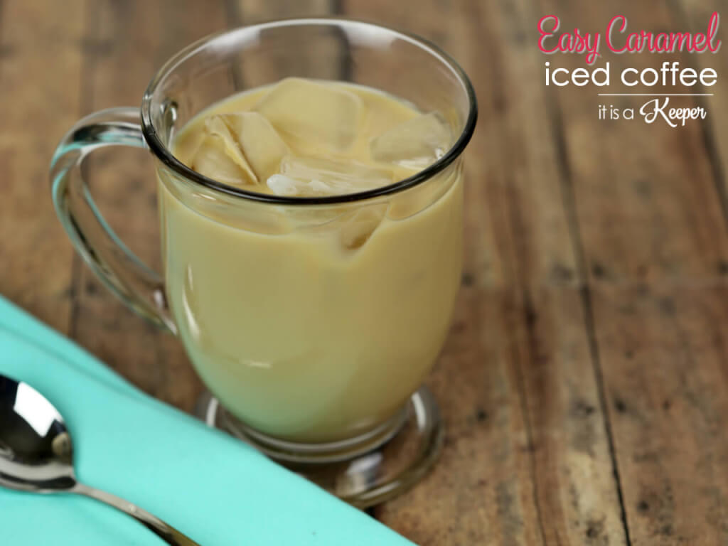 Easy Caramel Iced Coffee in a glass cup, with a metal spoon on a blue napkin. 