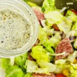 A picture of the vinaigrette being poured over the finished meal.