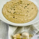 A white dish of the roasted garlic aioli.