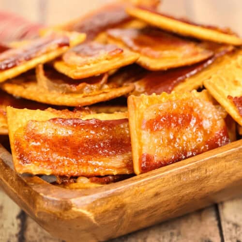 A bowl of delicious glazed bacon crackers.