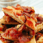 A stack of maple-bacon-crack squares on a plate.