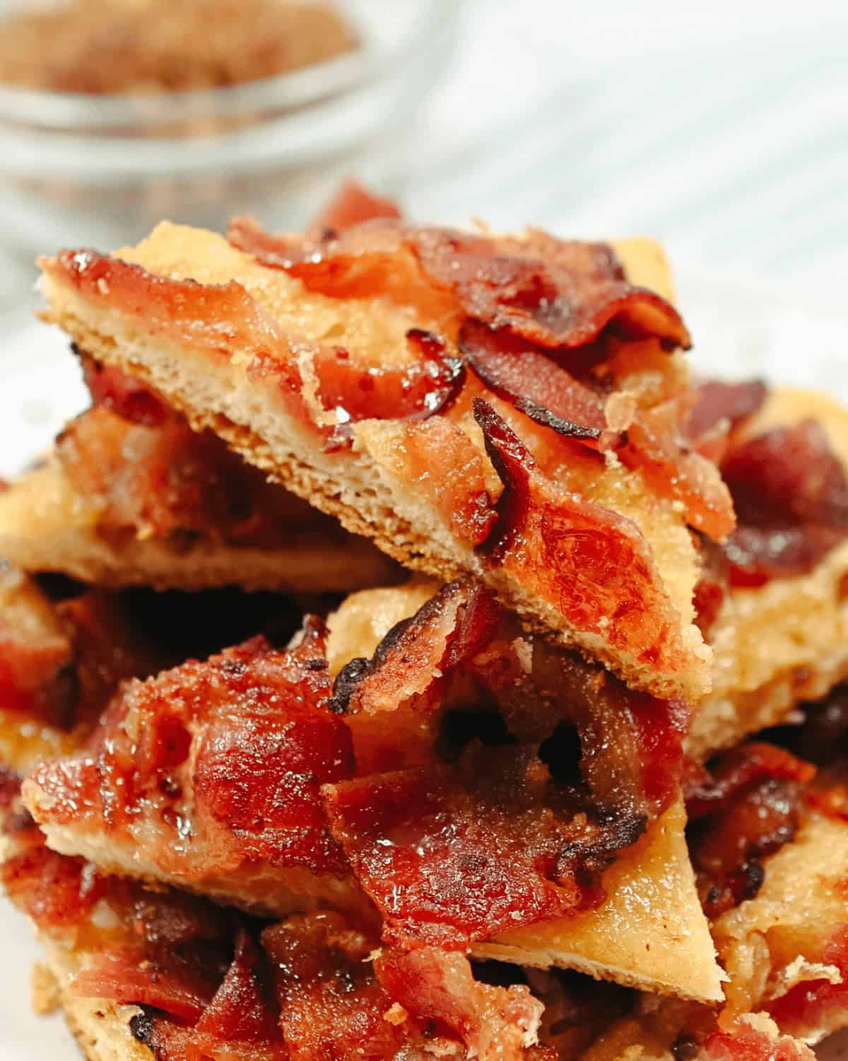 A stack of maple-bacon-crack squares on a plate.
