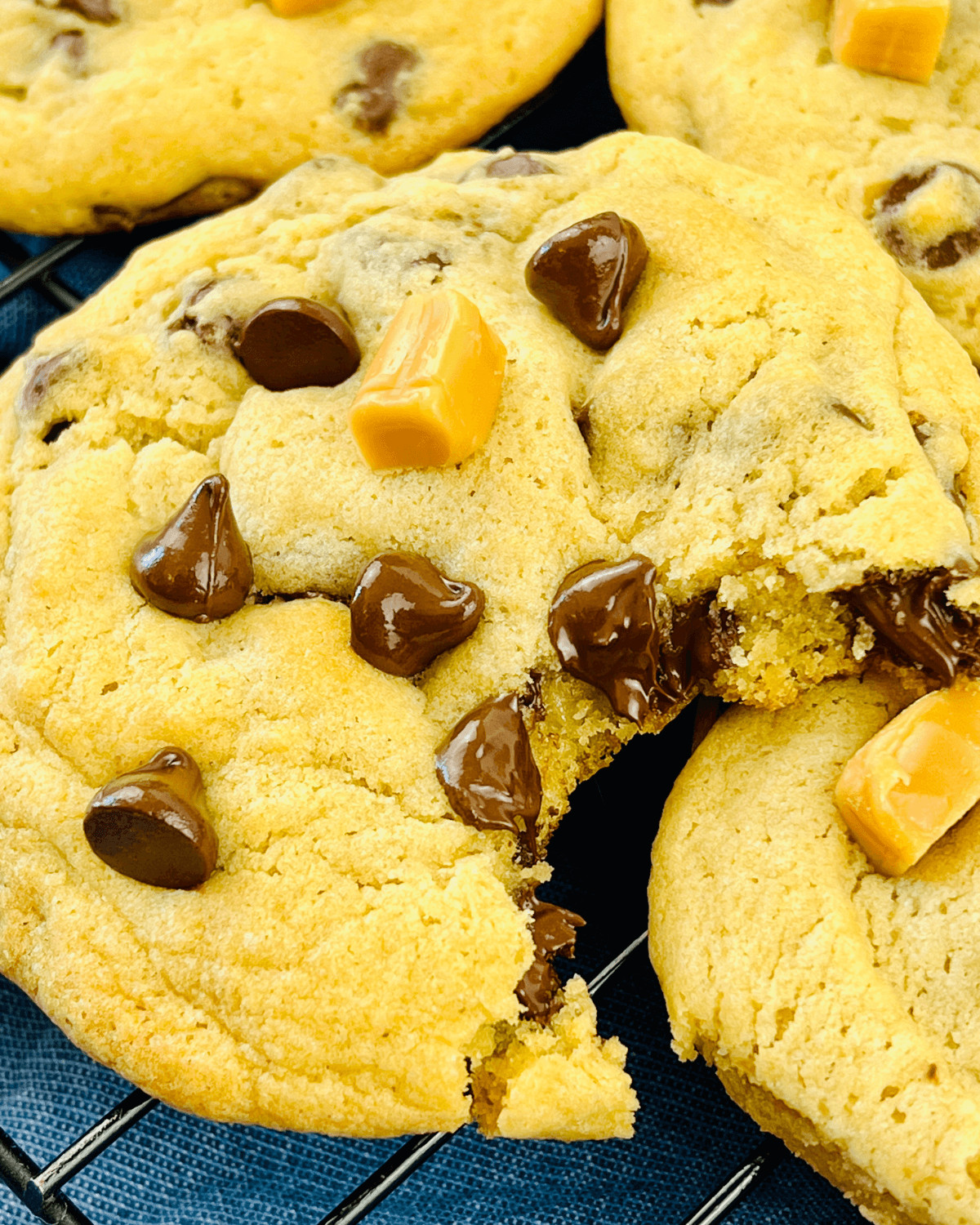 A Caramel Chocolate Chip Cookies with a bite taken out.